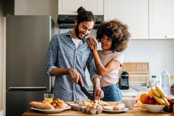 istock Passionate multi ethnic couple in kitchen preparing food and hugging 1414471793