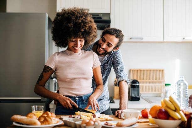 istock Passionate multi ethnic couple in kitchen preparing food and having fun 1414471797