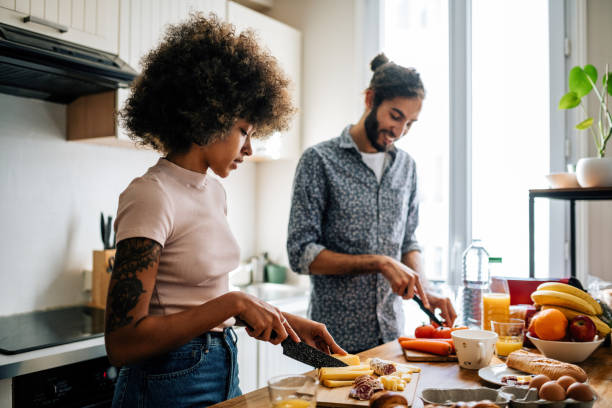 istock Passionate multi ethnic couple in kitchen preparing food and having fun 1414471807