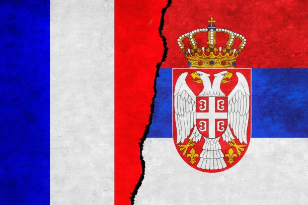 istock France and Serbia painted flags on a wall with a crack 1414472536