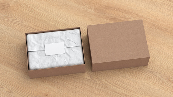 Gift box mock up with cover. Cardboard gift box with blank label or business card on wrapping paper. Wooden background. Side view. 3d illustration