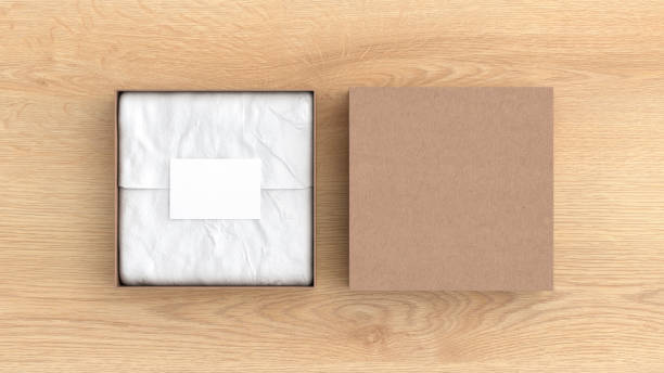 square gift box mock up. cardboard gift box with blank label or business card on wrapping paper. wooden background. view directly above. - cardboard box package box label imagens e fotografias de stock