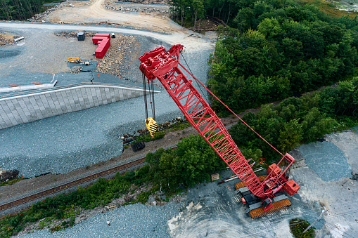 Drone view of a heavy lift crane on a highway construction site.