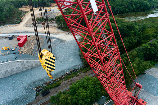 Drone view of a heavy lift crane on a highway construction site.