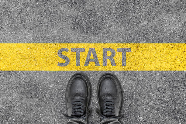 istock Starting line and sneakers on the asphalt ground 1414476369
