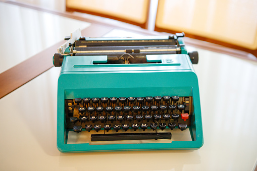an old black portable typewriter in an office setting