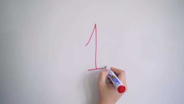 Hand Writing Number One On White Board With Red Marker
