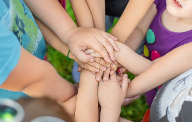istock Kids Staking Hands Outdoors 1414480563