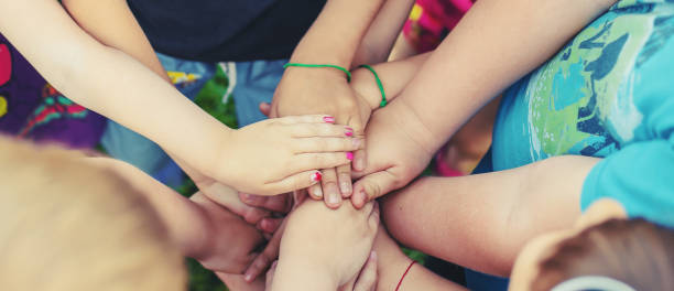 istock Kids Staking Hands Outdoors 1414480569