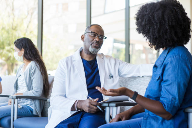 istock Doctor listens with a focused facial expression 1414481859