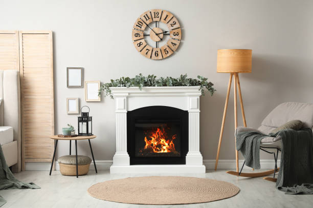 istock Stylish room decorated with beautiful eucalyptus garland on fireplace 1414484072