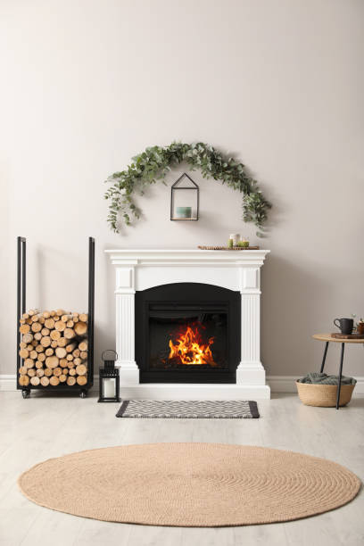 Stylish room decorated with beautiful eucalyptus garland above fireplace