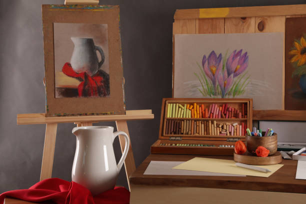 istock Artist's workplace with drawings, soft pastels and color pencils on table 1414484450