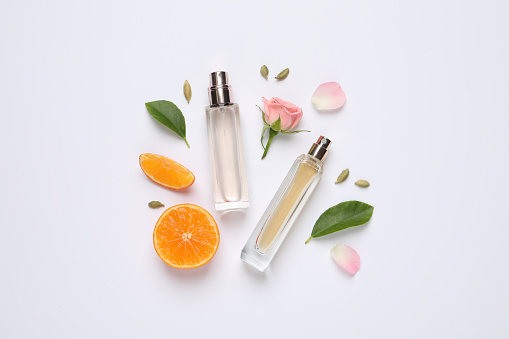 istock Flat lay composition with bottles of perfume, beautiful flower and tangerine on white background 1414484625