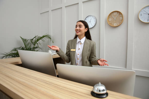 istock Beautiful receptionist working at counter in hotel 1414484690