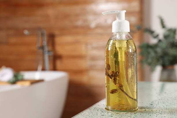 istock Dispenser of liquid soap on white table in bathroom, space for text 1414485799