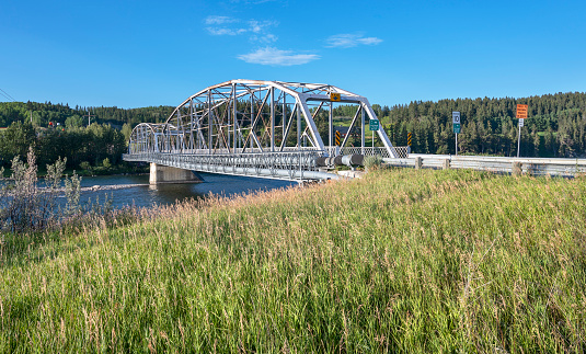 Old steel truss bridge crossing the Bow River at the town of Cochrane, Alberta