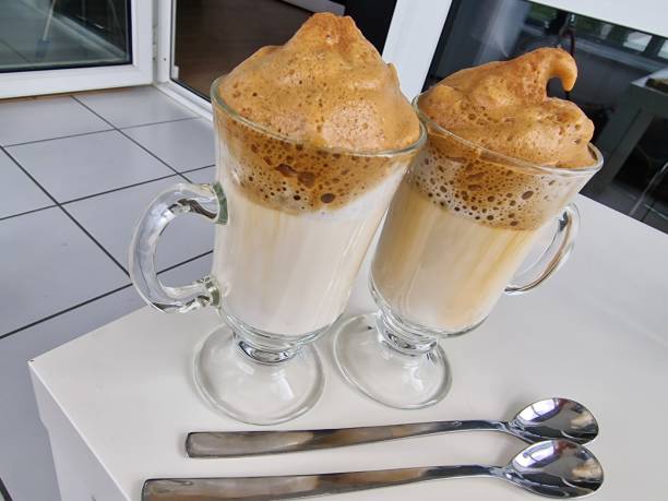 istock Two glasses with hot milk and coffee frothed 1414487486