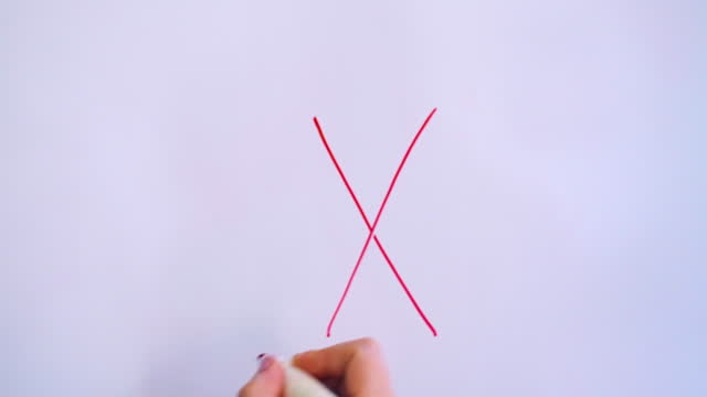 Hand Writing Capital Letter X On White Board With Red Marker
