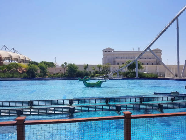 pool with clear blue water and two boats in the center in the amusement park Izmir, Turkey - August 13, 2020: a swimming pool with clear blue water and two boats in the center, as elements of an attraction in an amusement park top of water slide photos stock pictures, royalty-free photos & images