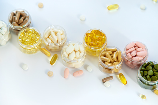 Supplements and vitamins on a white background. Selective focus. Medicine.