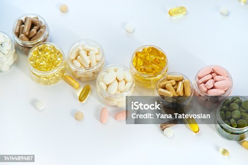 istock Supplements and vitamins on a white background. Selective focus. 1414489487