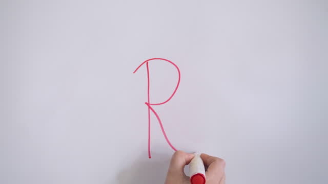Hand Writing Capital Letter R On White Board With Red Marker