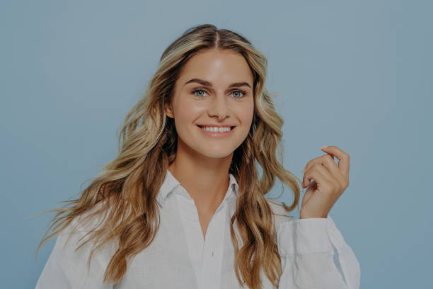 istock Beautiful caucasian female smiling broadly at camera demonstrating her white teeth 1414493302
