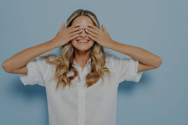 istock Blonde girl covering her eyes with hands 1414493305