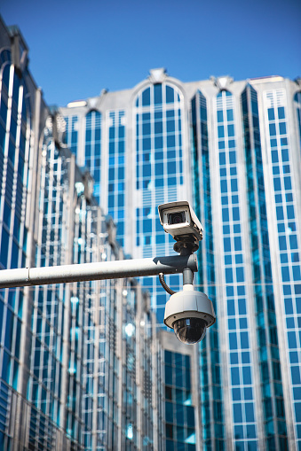 A CCTV surveillance camera on a modern city street being used for intelligence gathering and the focus of human rights liberties and laws