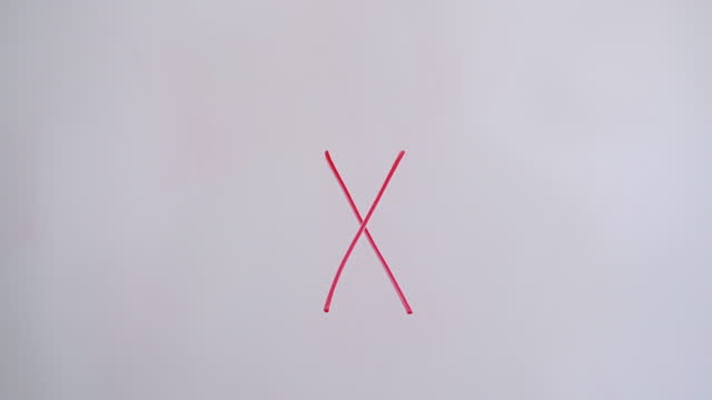 Hand Lowercase Letter x On White Board With Red Marker