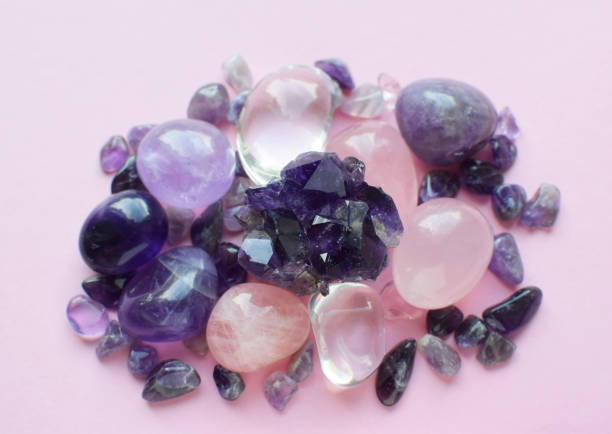 istock Gemstone minerals on a pink background. Round tumbling minerals amethyst, amethyst druse and rose quartz. 1414498366