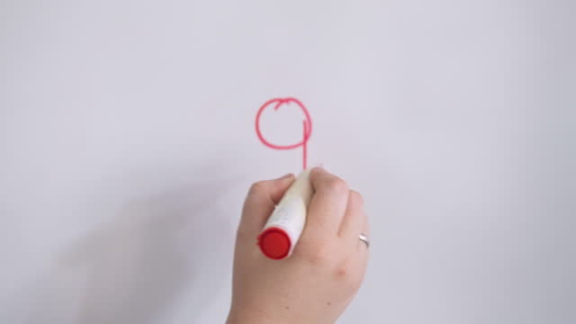 Hand Lowercase Letter q On White Board With Red Marker