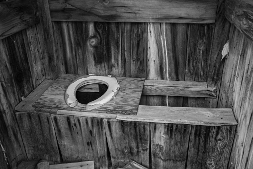 The toilet seat inside an old wooden outhouse in Bodie Ghost Town.