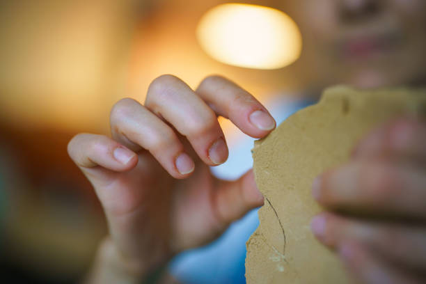 istock Close up to human hand ceramic scraping 1414503951