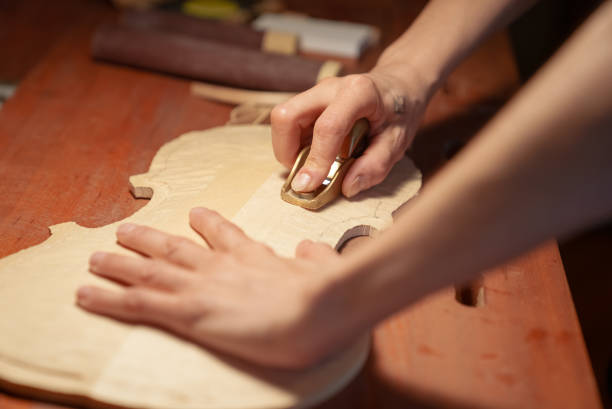 istock Close up to human hands making instrument, luthier 1414504074