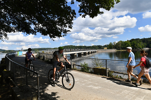 Limousin region, France-07 30 2022: Cyclists and hikers enjoying the tranquility of the Lac de Vassivière in the Limousin region in France.