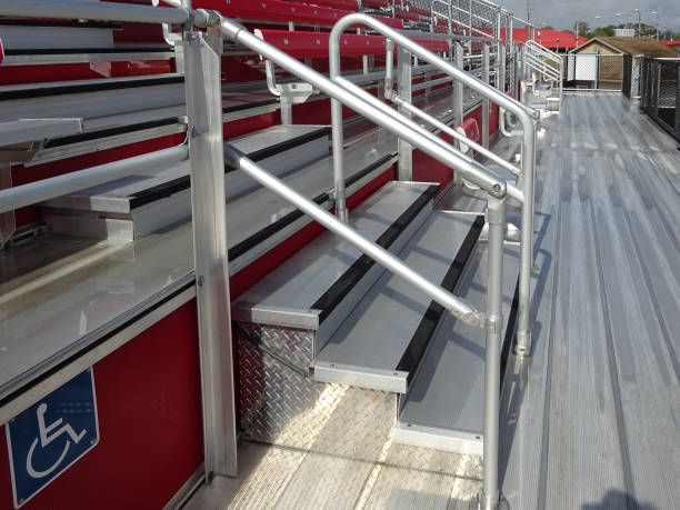 istock Closeup view of aluminum bleacher steps with railing and front walkway. 1414516514