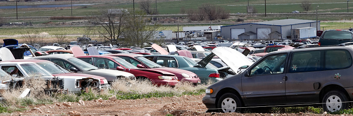 Aurora, Utah, USA-April 13, 2022: Rows of junked automobiles in a large salvage yard.