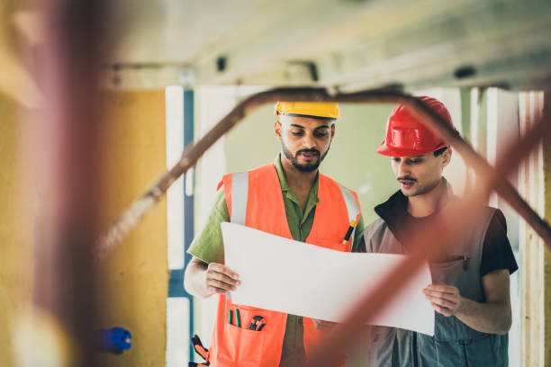 istock Colleagues reading documentation on site, inspection day 1414522786