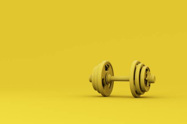 istock Yellow dumbbell isolated on pastel yellow background 1414524769