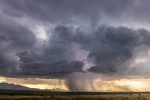 Lightning strikes during a monsoon storm southeast of Sonoita, Arizona just before sunset.