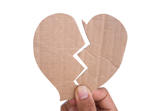 Hand woman holding broken heart paper shape isolated on white background.card or poster for valentine day,pain,problem couple,divorce,sad,love romantic,lonely concept.