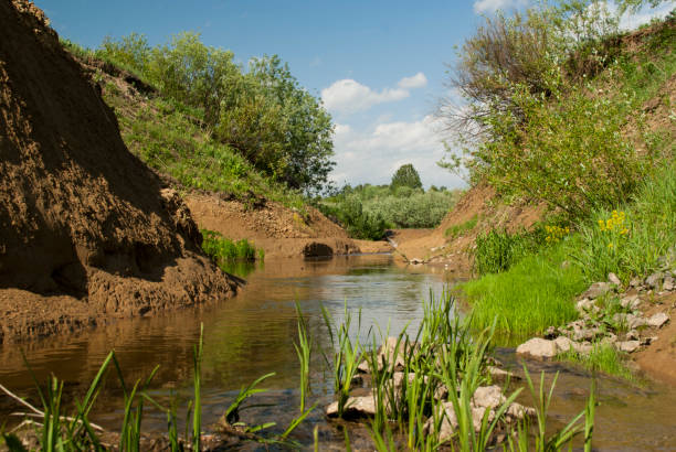 istock Waterfall and stream and lots of green trees and shrubs. 1414542790