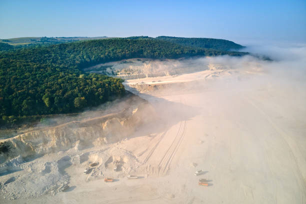 istock Aerial view of open pit mining of limestone materials for construction industry with excavators and dump trucks. 1414546387