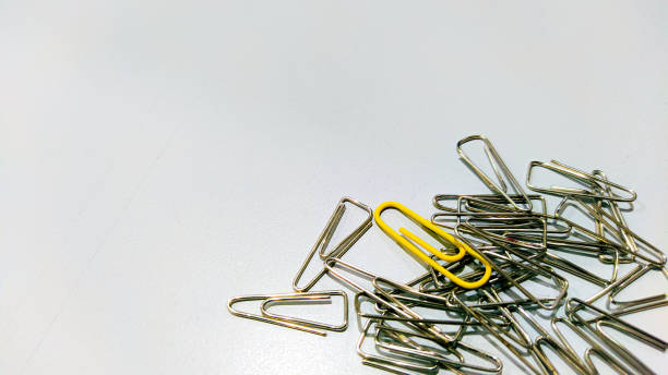 istock Yellow clip stand out from other clips 1414551966