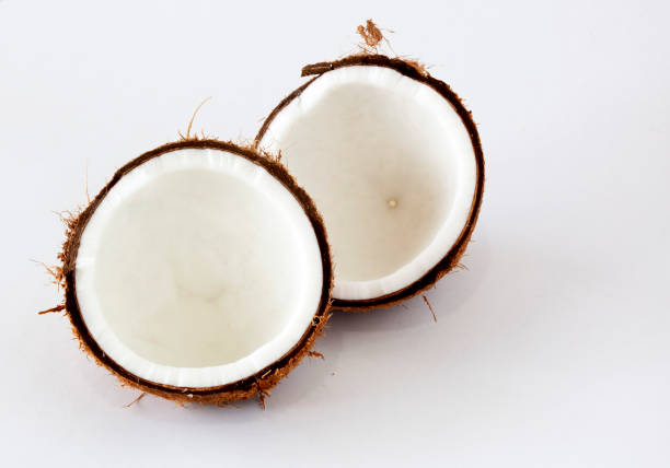 a half of coconut with white background on desk