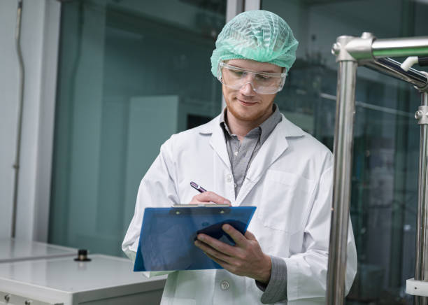 istock Scientists use clipboard in the machine room extracting oil and cannabis seeds 1414559461