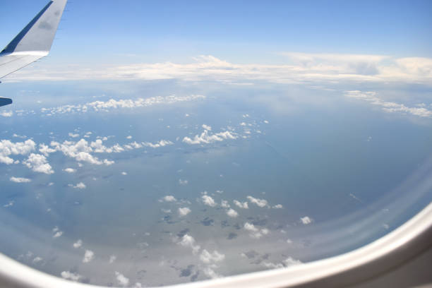 istock See-through aircraft a window at high altitude and beautiful high-altitude clouds floating over the sea on a sunny day. 1414560891