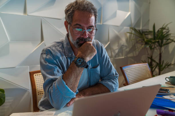 istock Elderly man checking bills at home 1414561875